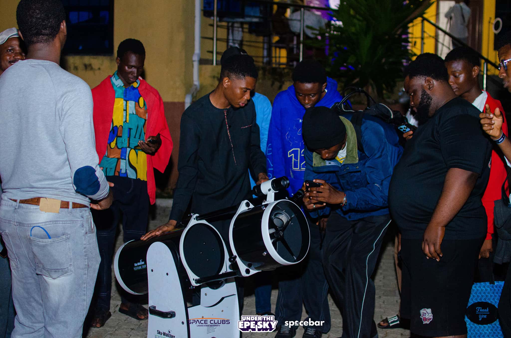 Members around the telescope